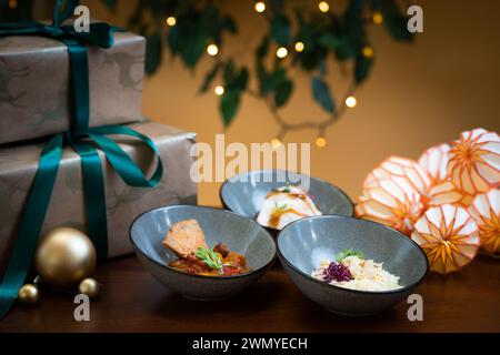 Celebrate in style with beautifully plated gourmet canapes on a festive table, complemented by tasteful decorations and warm lights. Stock Photo