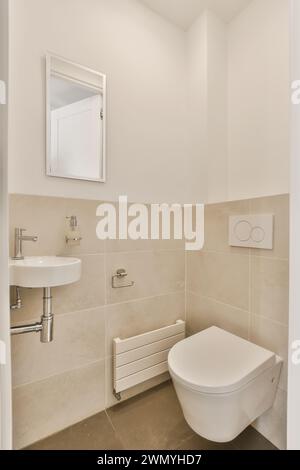 Modern minimalist bathroom interior with white fixtures and beige tiles. Stock Photo