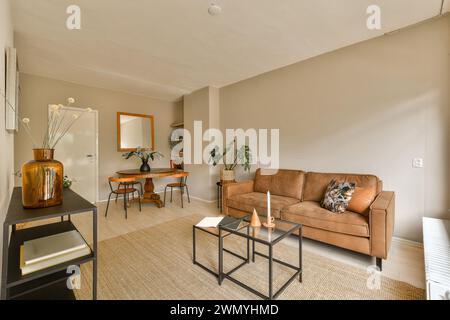 a living room with a couch and a glass table Stock Photo