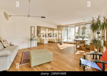 a living room with a couch and a dining room Stock Photo