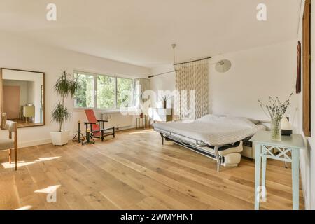 a bedroom with a bed and a table and a Stock Photo