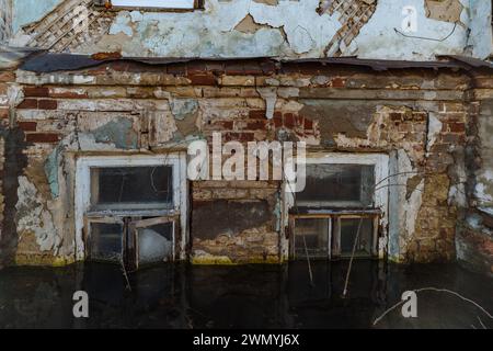 Flooded old house. Flooded old window. Natural disaster concept. Stock Photo