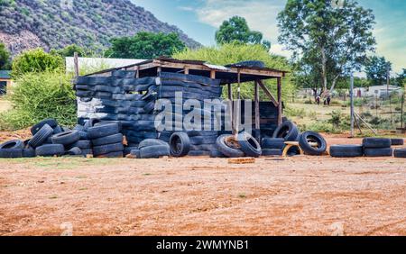 township informal settlement in africa near a hill, shack made out of tires Stock Photo