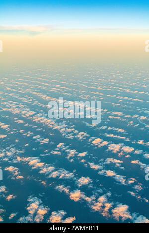 Evening cloudscape near the Canary Island of Lanzarote, Spain viewed from a passing aircraft towards sunset. Stock Photo