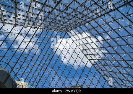 Low angle view of the glass facade of a modern building geometrically positioned proving abstract perspective Stock Photo