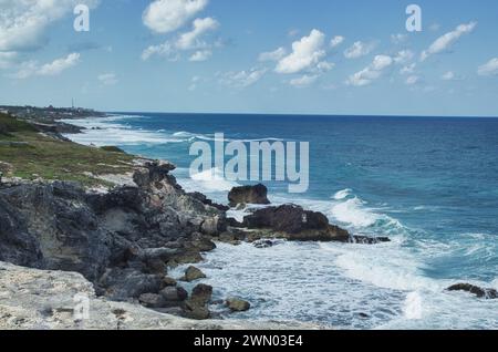 A dramatic view of strong waves and rough seawater splashing against the cliff in isla mujeres which is a small island off cancun, Mexico Stock Photo