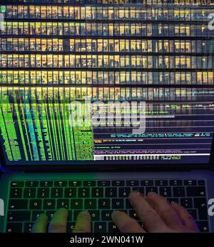 Symbolic image hacker, cyberattack on public buildings, administrations, institutions, town hall, authorities, digital blackmail, data theft, online c Stock Photo