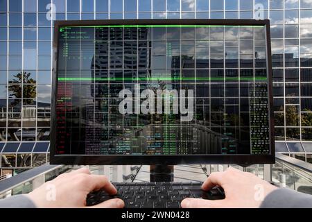 Symbolic image hacker, cyberattack on public buildings, administrations, institutions, town hall, authorities, digital blackmail, data theft, online c Stock Photo