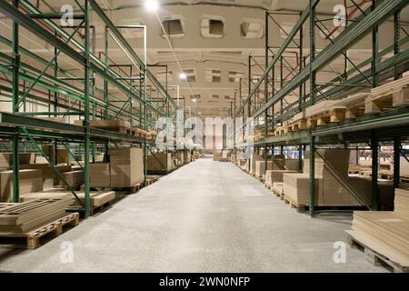 Interior of spacious industrial warehouse with metal shelves Stock Photo