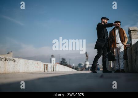 Two businessmen engaging in an outdoor business discussion on a sunny day. Stock Photo