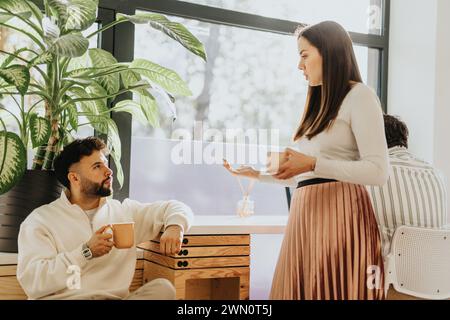 Business team discussing project details in office workspace. Stock Photo