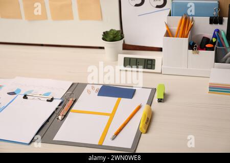 Business process planning and optimization. Documents with different types of graphs and stationery on wooden table Stock Photo
