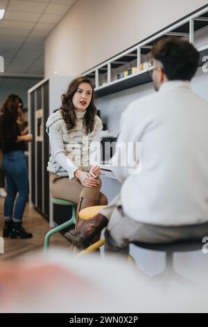 Businesspeople enjoying a pleasant atmosphere while brainstorming ideas over coffee in a modern kitchen. Stock Photo
