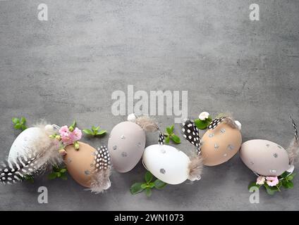 Collection of stylish colors eggs with flowers for Easter celebration on grey background. Holiday concept. Stock Photo