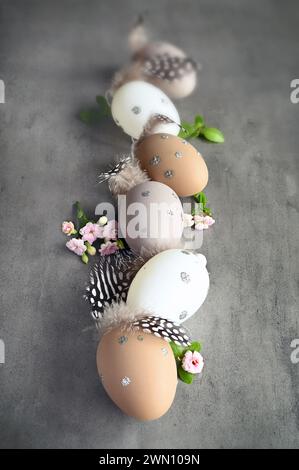 Collection of stylish colors eggs with flowers for Easter celebration on grey background. Holiday concept. Stock Photo