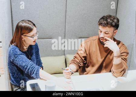 Focused colleagues discussing project strategy at modern office. Stock Photo