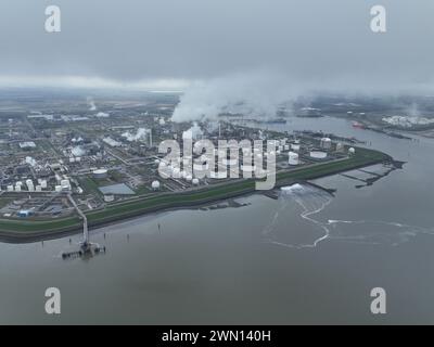 Chemical industry at terneuzen. DOW chemical park and petrochemical storage containers. Smokestacks and heay industry. Birds eye aerial drone view. Stock Photo