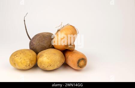 View from the front. Potatoes, onions and beets isolated on a white background. Stock Photo