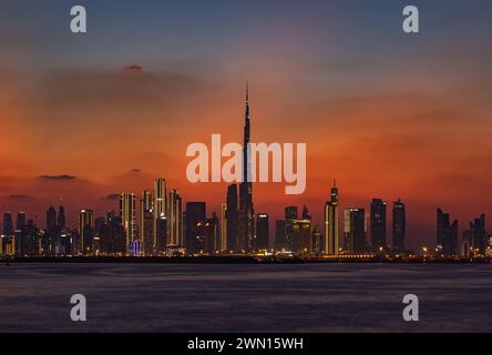 A colorful picture of Downtown Dubai at sunset, with the Burj Khalifa towering the other high rises. Stock Photo