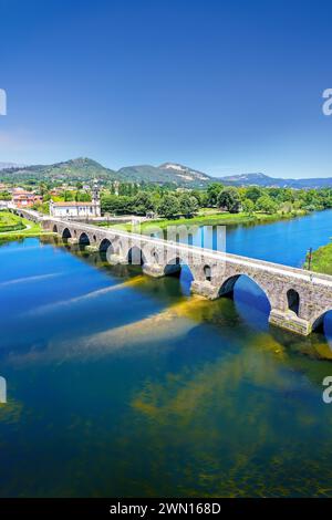 An elevated view of the beautiful medieval bridge crossing the River Lima, Portugal, which dates back to 1368. Stock Photo