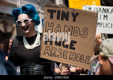 London, UK. 13th July 2018. Protester holding up campaign posters and placards, at the #BringTheNoise Women's March Anti Donald Trump protest demonstration through the streets of central London, UK. Stock Photo