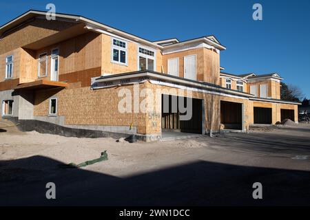 Duplexes and townhomes under construction in the Rockrimmon area of northern Colorado Springs, Colorado.  Large two car garages are featured. Stock Photo