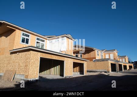 Duplexes and townhomes under construction in the Rockrimmon area of northern Colorado Springs, Colorado.  Large two car garages are featured. Stock Photo