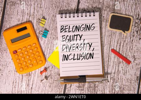 Equity, diversity, inclusion, belonging. Text on notebook with coffee and eyeglasses. Business, signs Stock Photo