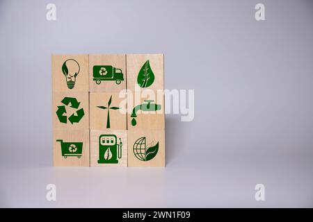 The green wooden blocks placed on the Laptop with symbols and texts ' reduce, reuse and recycle' . It is the concept of reducing the electronic waste, Stock Photo