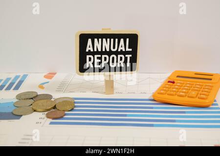 Business Annual Report text on a black folder near a cup of coffee. light wooden background. Stock Photo