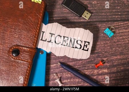 Business person presses his finger on the wooden cubes with the word licensing. Copyright protection law license property rights Stock Photo