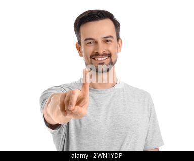 Handsome man using virtual screen on white background Stock Photo