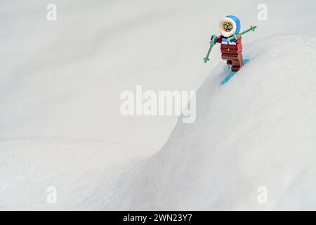 Chappaqua, NY - Feb 13 2024 - Funny humorous scared expression on Lego minifigure weekend warrior overconfident beginning downhill skier getting into Stock Photo