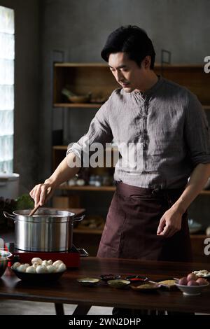 Cook making dishes in the kitchen Stock Photo