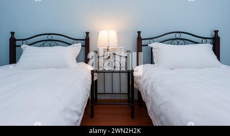 Two separate beds in a hotel family bedroom Stock Photo