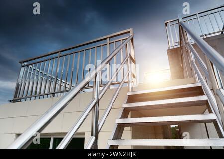 New metal staircase and handrail on the top of modern building Stock Photo