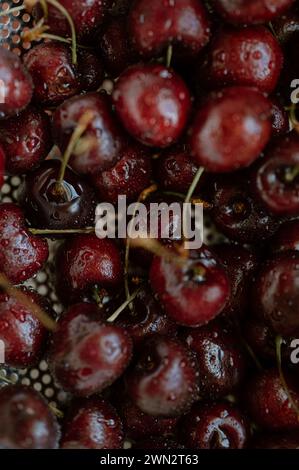 The freshly washed cherries glisten with the promise of summer's sweetness, inviting a burst of flavor with every bite Stock Photo