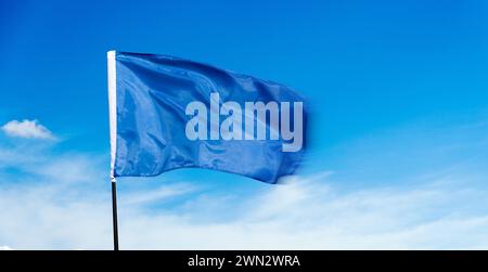 Blue flag waving on blue sky Stock Photo