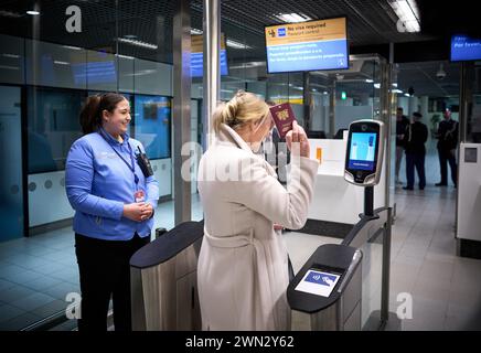 SCHIPHOL - Passengers go through check-in gates at Schiphol Airport ...