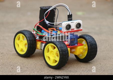 Programmable robotic car built using micro controller and ultrasonic distance sensor along with servos and dc motor. Working prototype of a car Stock Photo