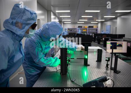 (240229) -- BEIJING, Feb. 29, 2024 (Xinhua) -- Yang Xiaojun (R) adjusts experimental equipment at a laboratory of MICROMACH in Xi'an, northwest China's Shaanxi Province, Jan. 17, 2024. Yang Xiaojun is director of the Photonic Manufacturing Systems and Application Research Center of Xi'an Institute of Optics and Precision Mechanics, Chinese Academy of Sciences (CAS). He was employed by the institute after graduating with a Ph.D degree in 2008, and led his team to incorporate the MICROMACH company in 2015 to speed up the industrial application of his achievements in ultra-fast laser manufacturi Stock Photo