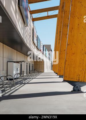 exterior view of Atrium Felicity shopping mall on a sunny day - perspective view of brown wood-colored pillars along the beige facade. Stock Photo