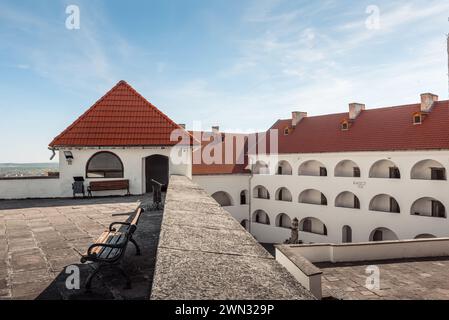 terrace overlooking interior courtyard of Palanok Castle on a sunny day. Tower on top of medieval castle in Zakarpattia Stock Photo