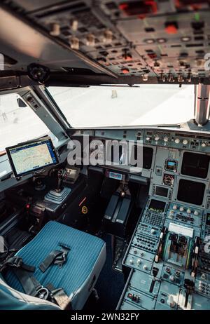 Point of view of First pilot's seat - Brussels Airlines' Airbus A320 (OO-SNA). Empty airplane cockpit with electronic nav panel, buttons and levers. Stock Photo