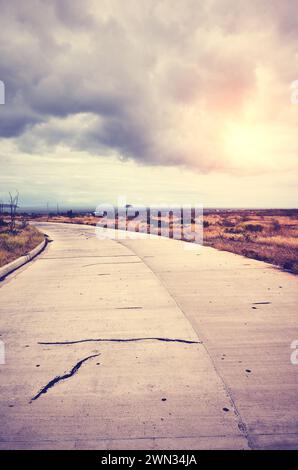 Vintage toned scenic road at sunset, travel concept, Baltra Island, Ecuador. Stock Photo