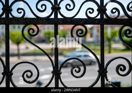 Detail of a wrought iron fence on a street in the city. Shallow depth of field. Stock Photo