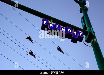 People riding super hero style on the Slotzilla Zipline at the Fremont Experience in Las Vegas, Nevada Stock Photo