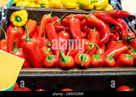A bunch of red peppers in a basket close up Stock Photo