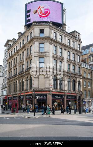 People pass by the Angus Steakhouse restaurant on corner of Coventry Street and Haymarket Piccadilly Circus London England UK Stock Photo