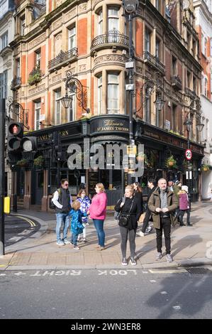 People walking in Soho outside St James Tavern, a traditional pub at the corner of Great Windmill Street and Denman Street Soho London UK Stock Photo